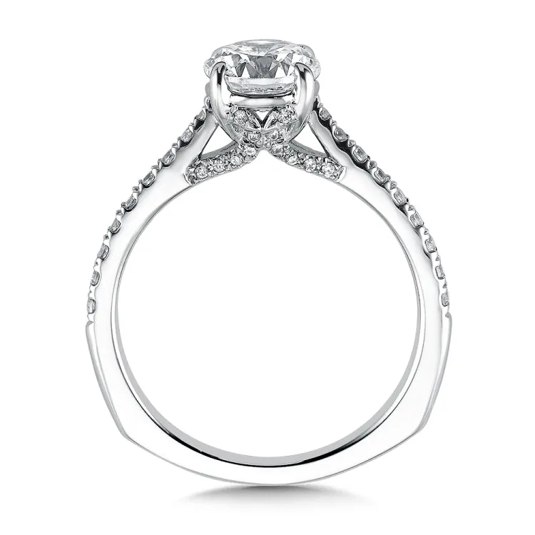 A unique diamond finger rest in this beautiful solitaire ring design sets the stage for the dazzling center stone.